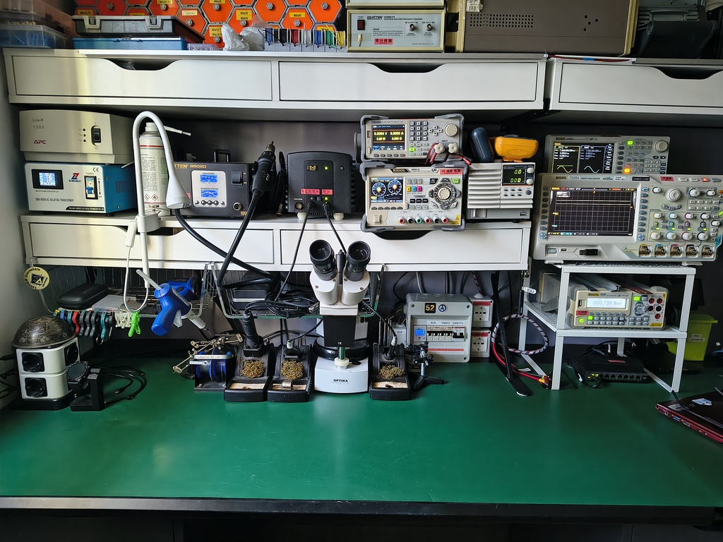 Instrumentation bench — oscilloscopes, power supplies, microscope